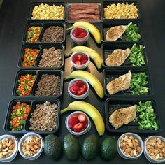 an assortment of fruits, vegetables and meats arranged in trays on a table