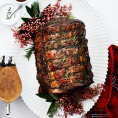 a large piece of meat sitting on top of a white plate next to a cup of coffee