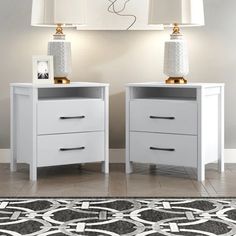 two white nightstands sitting next to each other on top of a carpeted floor