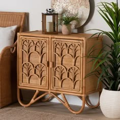 a wicker cabinet with a round mirror on top next to a chair and potted plant