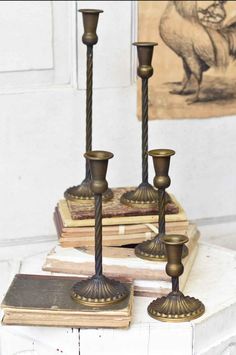 three candles are sitting on top of some books