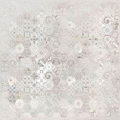 a white and gray rug with many different designs on the carpet, including an abstract design