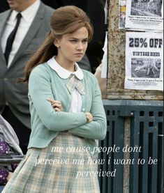 a girl in a school uniform with her arms crossed