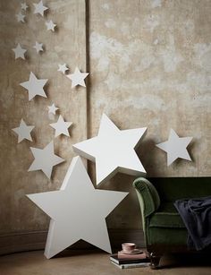 white stars on the wall next to a green chair