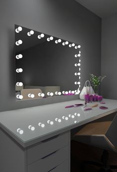 a white desk topped with a mirror and lights