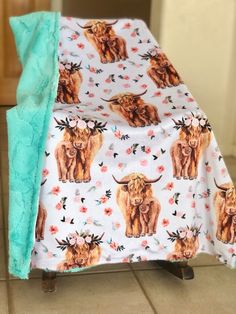 a blanket with an image of a bull and flowers on it is sitting on a chair