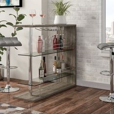 a bar with two stools in front of a window and a potted plant