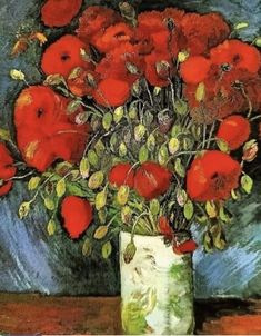 a vase filled with red flowers sitting on top of a wooden table next to a painting