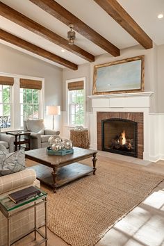 a living room filled with furniture and a fire place in the middle of a room