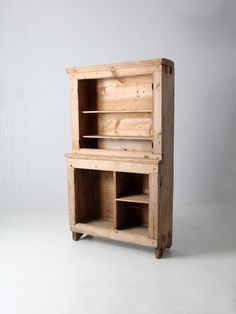 a wooden cabinet sitting on top of a white floor