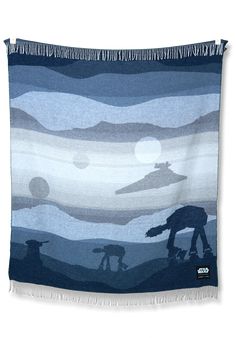 a blue and white blanket with a star wars scene on it