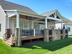 a house with a porch and stone pillars