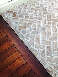 a wooden floor with a brick pattern on it and a door in the back ground