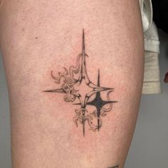 a close up of a person's leg with a tattoo on the lower thigh