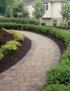 a brick pathway in front of a house