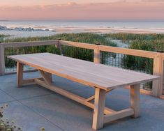 a wooden bench sitting on top of a cement floor