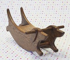 a wooden toy boat on a polka dot table cloth