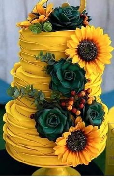 there is a yellow cake with sunflowers on it