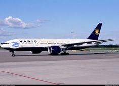 a large white and blue jetliner sitting on top of an air port run way