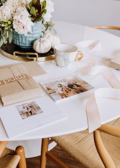 the table is set up with photos, flowers and napkins for guests to eat