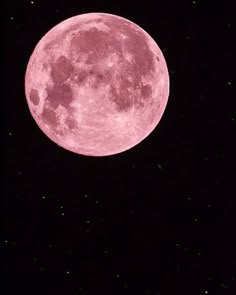 the full pink moon is seen in the sky with stars on it's sides