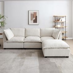 a living room with a large white sectional couch