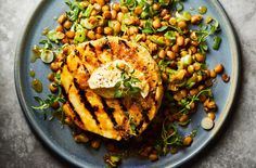 a blue plate topped with grilled chicken and chickpeas