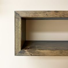 an empty wooden shelf hanging on the wall