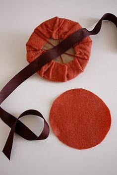 two pieces of felt are tied together with brown ribbon