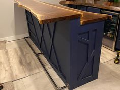 a kitchen island made out of wood and metal