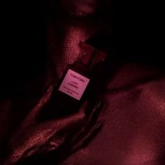 a bottle of perfume sitting in the dark