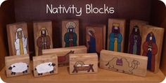 wooden nativity blocks with pictures of sheep, jesus and shepherd on them in a box