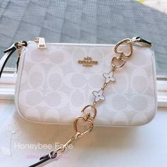 Coach CS442 Nolita 19 In Signature Canvas Glacierwhite + an extended chain Coach Nolita 19 White, Affordable Purses And Handbags, Coach Bag With Charms, Couch Bags Coach Handbags, Coach Pink Purse, Cute Designer Bags, Cute Purses For Teens, Cute Purses Aesthetic, Cute Bags And Purses