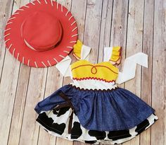 a cowgirl outfit and cowboy hat on a wooden floor