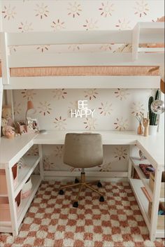 a white desk with a chair underneath it and shelves below the desk that have books on them