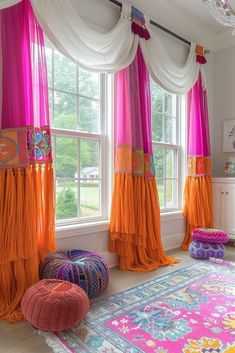 a room with pink and orange drapes on the windowsills, colorful poufces hanging from the ceiling