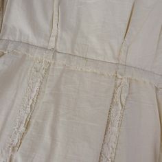 "Ivory Lace lined in a soft cotton. This lovely vintage dress has short sleeves, buttons up the front with a snap at the waist and the top. The shoulder detail adds a quirky, unusual element and the same fabric is used to cover the buttons and for the piping at the neckline and front. The dress has a fitted bodice and features a slightly flared skirt hitting a below the knee. I picture this dress paired with gloves and a veiled fascinator. The label says Mann Mate Orginal. The lace is in great s White Vintage Dress With Buttons For Spring, Cotton Vintage Dress With Buttons For Summer, Vintage White Cotton Dress For Spring, Vintage Summer Dresses With Covered Buttons, Cotton Vintage Dress With Buttons, Cream Short Sleeve Vintage Dress For Summer, Summer Vintage Cotton Dress With Buttons, Beige Vintage Dress With Short Sleeves For Daywear, Vintage White Short Sleeve Dress