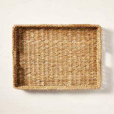 an empty wicker tray on a white wall