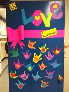 a bulletin board decorated with handprints and words that read love, learnly