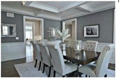 a dining room table and chairs with white trim