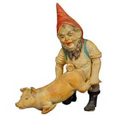 a small statue of a man sitting on top of a pig