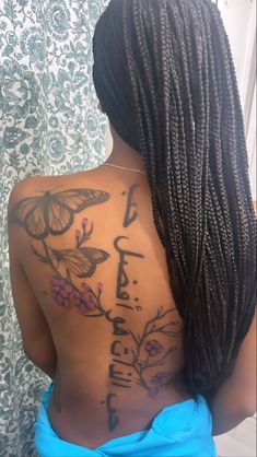 a woman with butterfly tattoos on her back