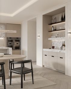 a modern kitchen with marble counter tops and white cabinets, along with two black chairs