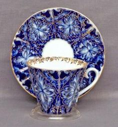 a blue and white tea cup on a saucer