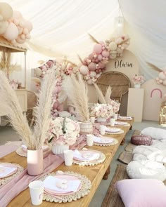 the table is set with pink and white decorations