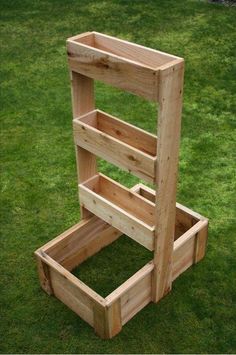 a wooden shelf sitting on top of green grass