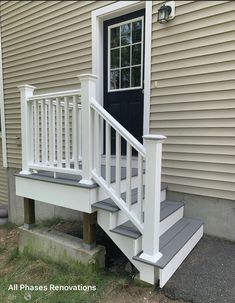 a white porch with steps leading up to the front door