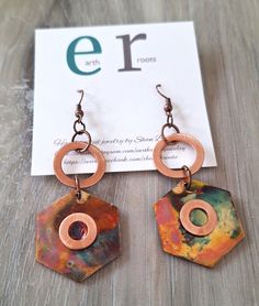 the earrings are made out of copper and has a circular design on each earring