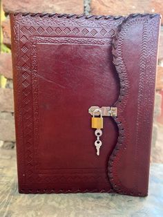 a red leather book with a key on it