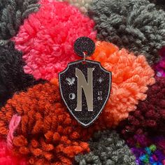 a close up of a knitted object with a letter n on it